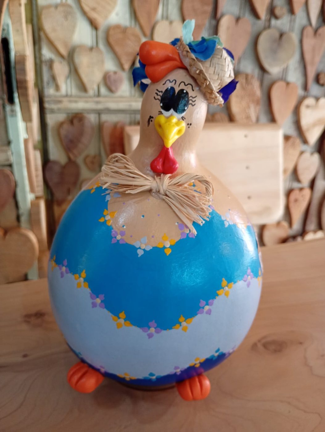 Galinha de cabaça porta-ovos com chapéu de flores azuis, corpo pintado em tons de azul